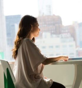 two women sitting beside table and talking